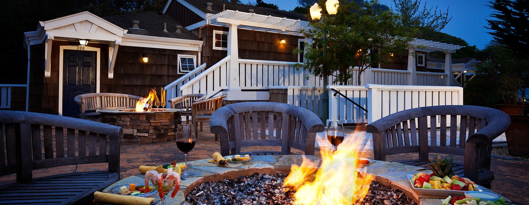 fire pit with food and cottage in background