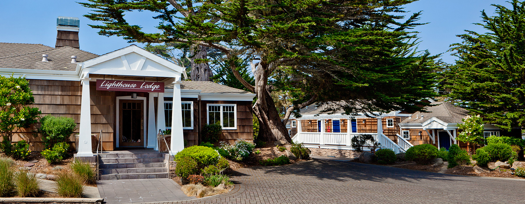 hotel exterior with green trees and blue sky